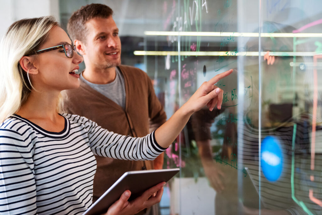 Business solutions, technology, success and strategy concept. Colleagues working and brainstorming in office